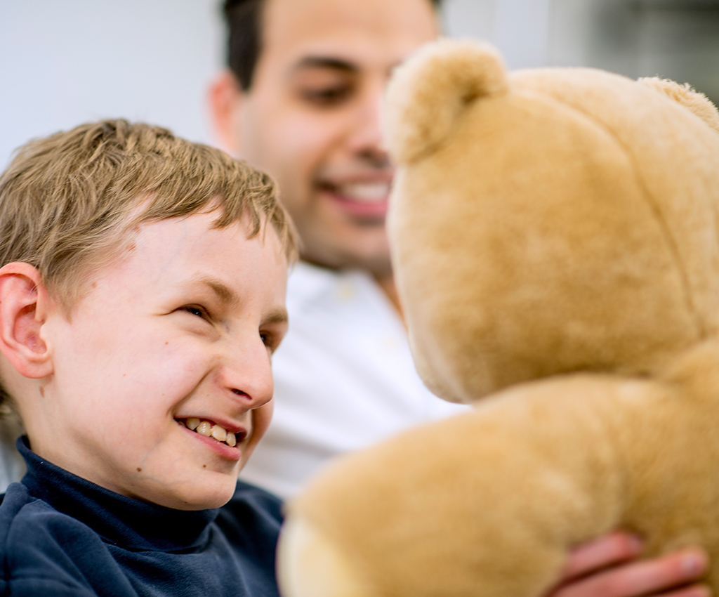 young boy holding a teddy bear