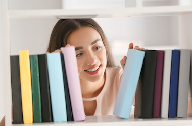 woman looking at books on a shelf